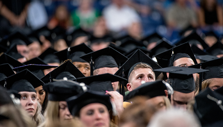 audience of graduates in black caps
