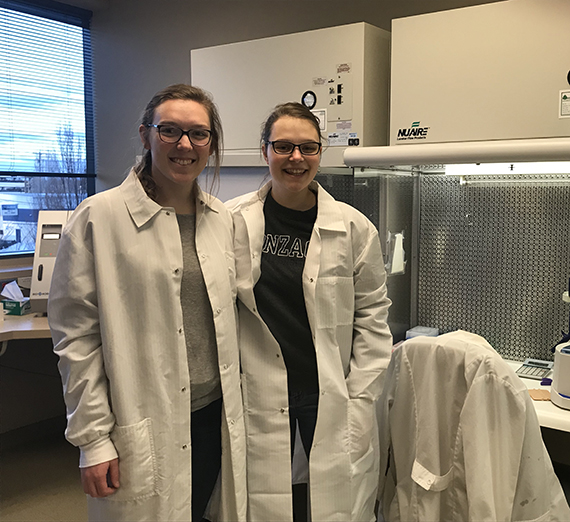 Claire Henson and Megan Sathoff, student interns, stand together at a medical facility.