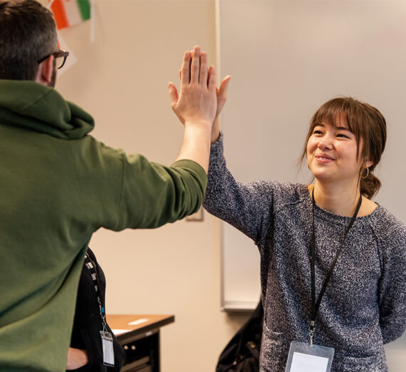 student and teacher high-five