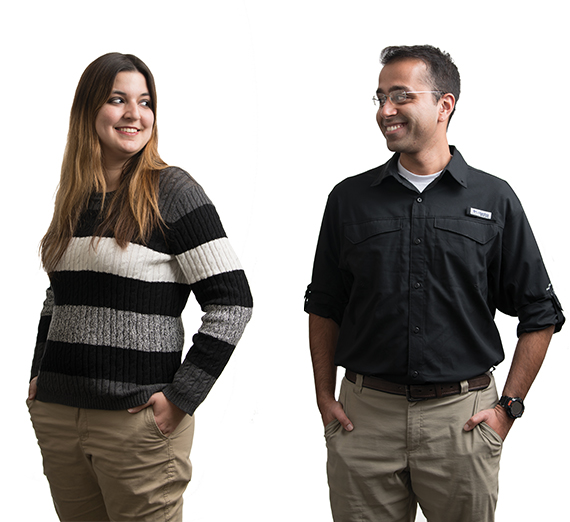 New faculty Shannen Cravens and Harman Khare smile at each other. 