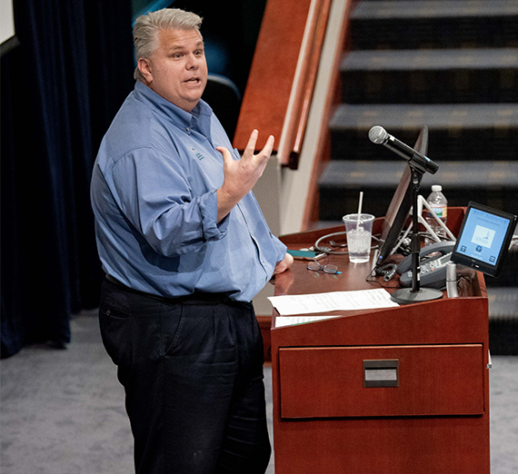 Rob McCann speaks at a podium. 