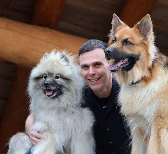 researcher Matt Kaeberlein with two dogs 