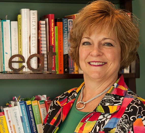 Robyn Holder in front of bookshelf