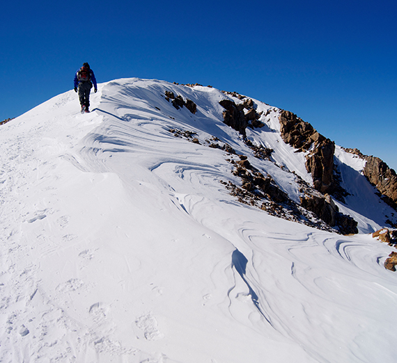 Greg Onofrio approaches the peak of Mt. Elbert in the snow. 