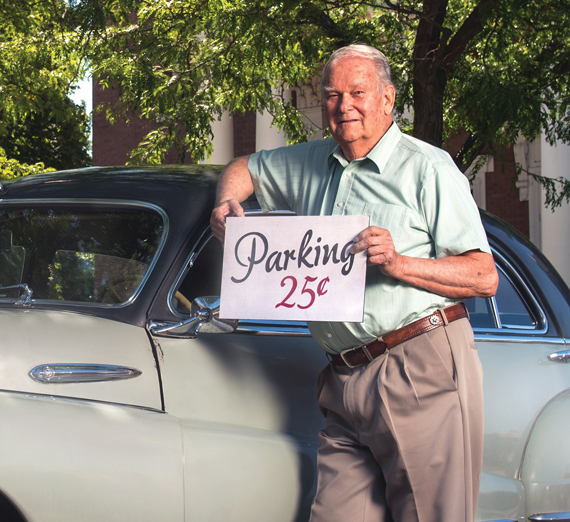 Don Rockstrom with "Parking 25 cents" sign