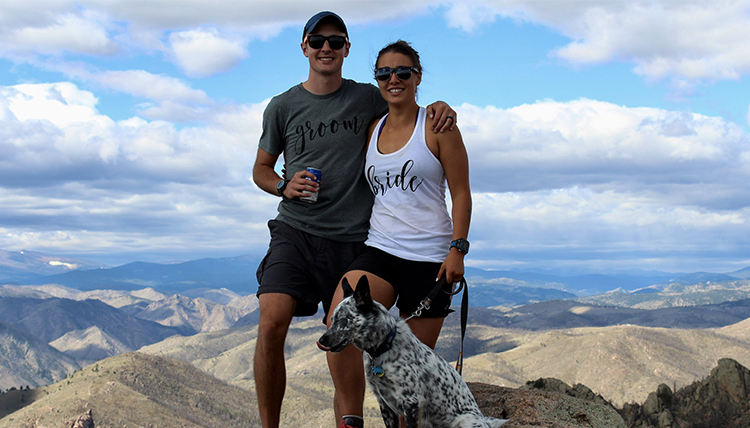 gonzaga couple and their dog atop a mountain