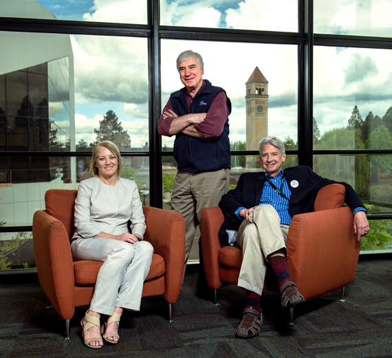 Mike Kobluk, Kevin Twohig, and Stephanie Curran in a building overlooking the Spokane clock tower.