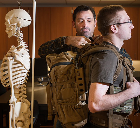 Brian Higginson fits a student with a backpack.