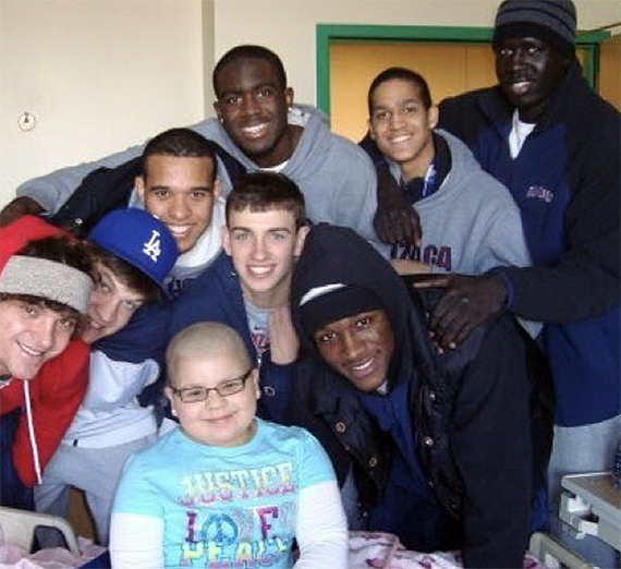 Briana Hermsmeyer surrounded by Gonzaga basketball players in 2010 at the hospital when she was being treated for bone cancer.