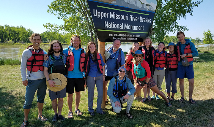 The group of students and staff pose in front of the Missouri Breaks sign