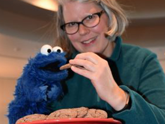 Molly McFadden holds a homemade cookie and her Cookie Monster puppet. 