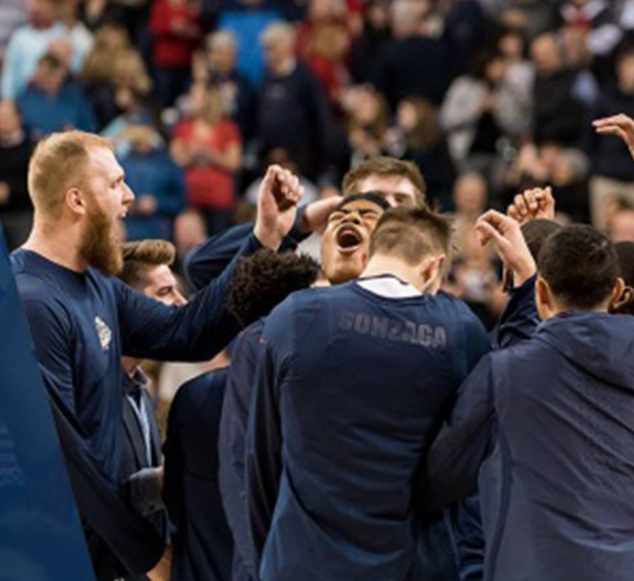 The men's basketball team celebrate after a game.  