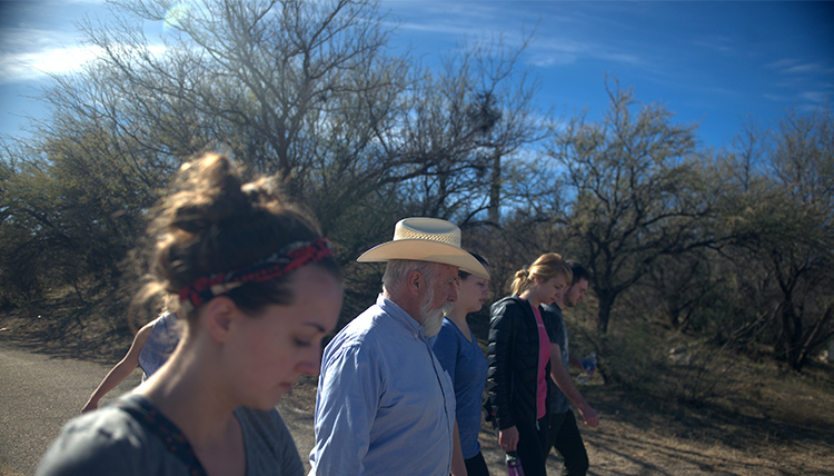 Fr. Pete Neeley walks with Gonzaga students into the bright sun of the Sonoran Desert