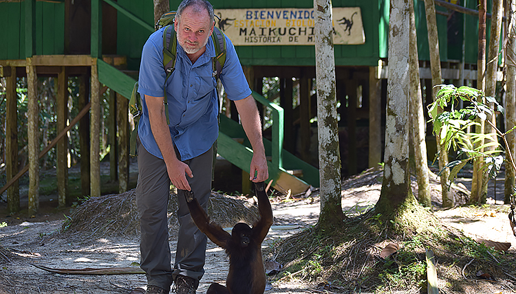 Associate Professor of Environmental Studies Dr. Greg Gordon poses for a photo with a monkey
