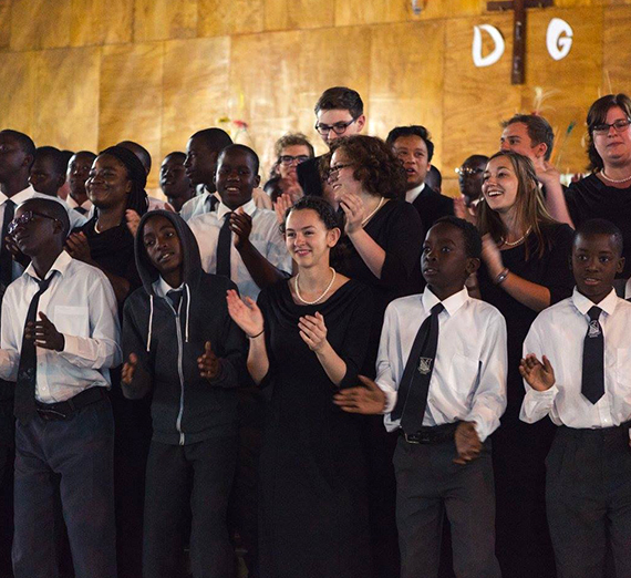 Gonzaga University choir members singing with youth in Zambia, Africa