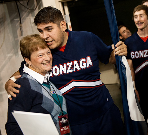 sister Laura hugs a member of the GU cheer squad before a game