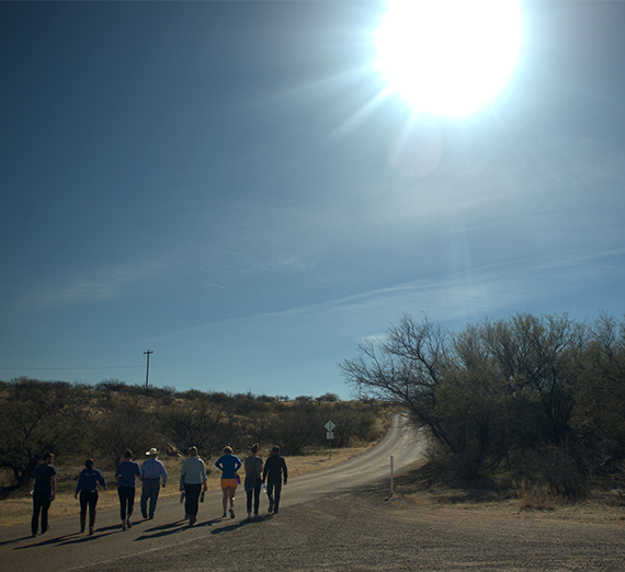 sun shining over walkers in Sonoran Desert 