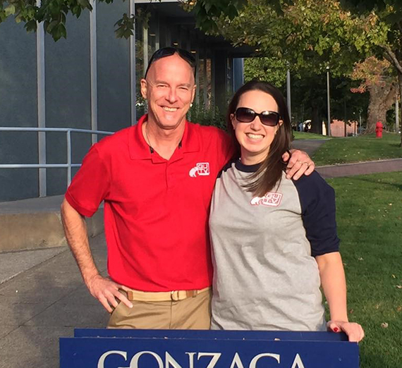 Jessica Michaels and Dan Garrity stand side-by-side in front of journalism building