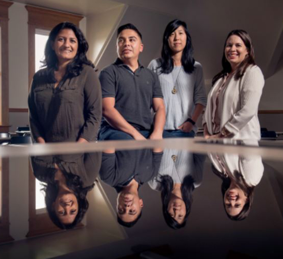 Gonzaga's UW Diversity Post-Doctorate Fellows gather around a table in College Hall