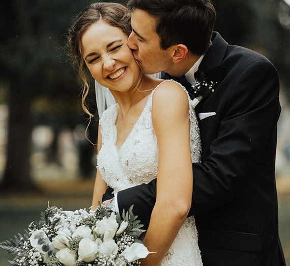 gonzaga grads marry, groom kisses bride 