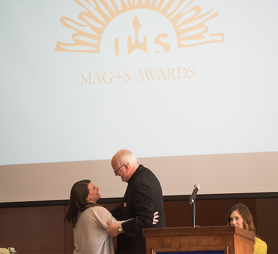 Recipients of the Magis Award embrace during the ceremony. 