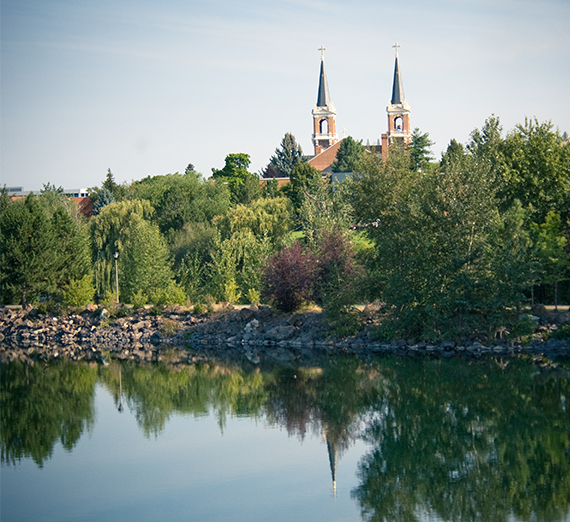 The spires of St. Aloysius Church are reflected in the waters of Lake Arthur