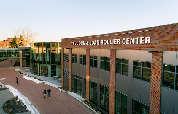 Overhead shot of the Bollier Center for Integrated Science and Engineering. The building is a large brick building with large glass windows across the two stories. In the background is the sky bridge and glass rotunda connecting the Bollier Center to the Herak Building.