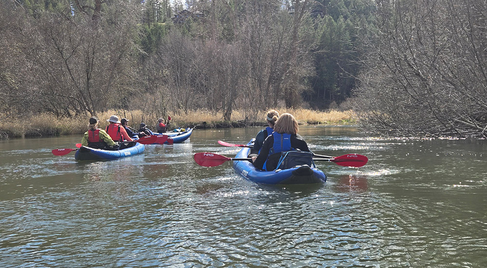 faculty on kayaks in a river