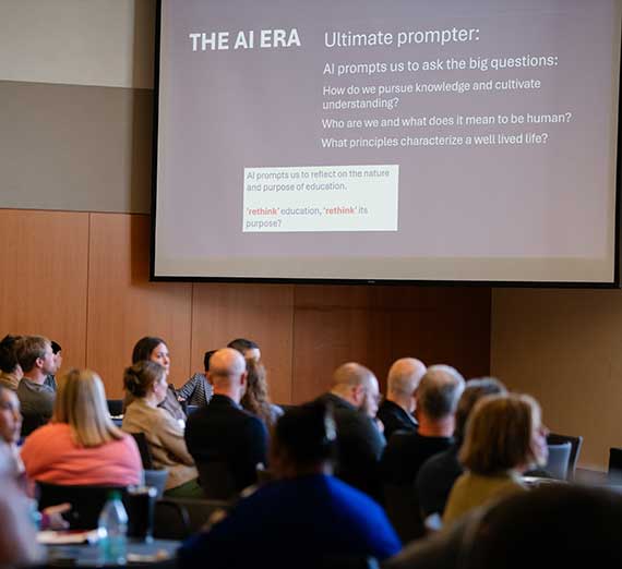 Audience viewing a presentation on a large screen.