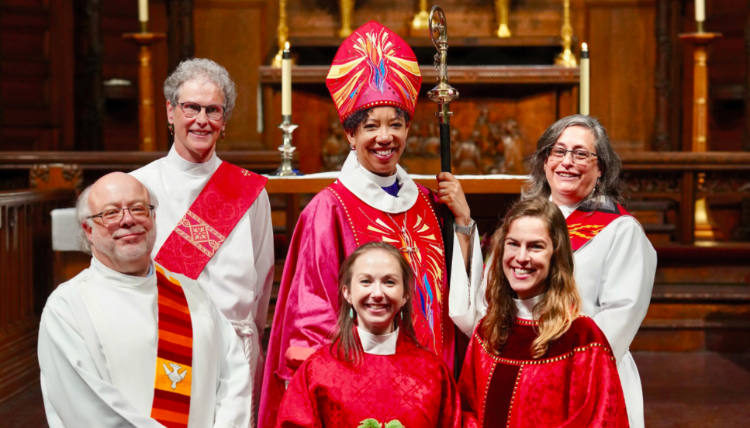 Group of religious leadership, including Reverend Amanda Newell Large and Bishop.