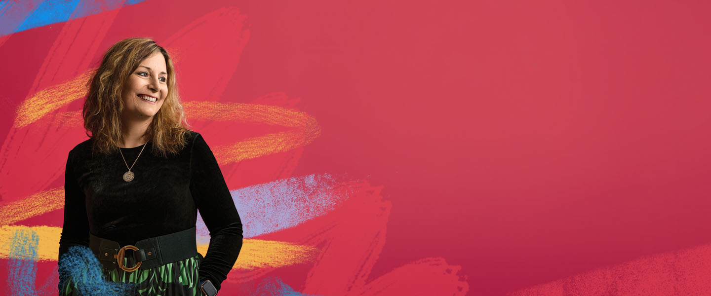 woman in black against vibrant red background and artistic flare