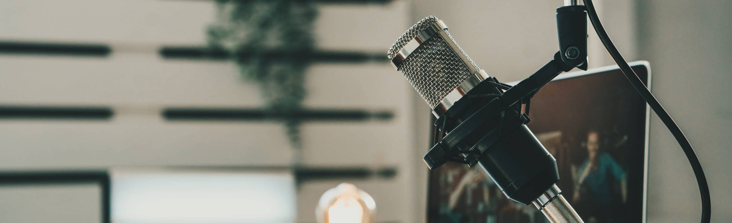 Podcast setup, with a laptop and microphone