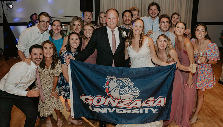 large wedding party with gonzaga flag