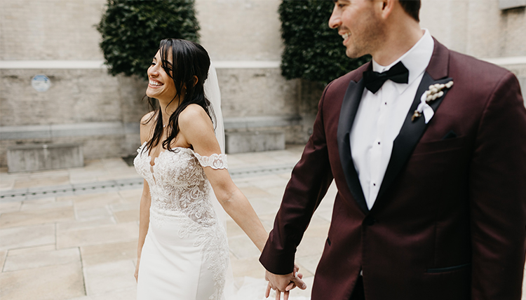 bride and groom holding hands