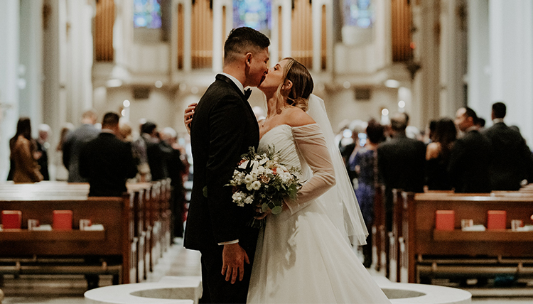 bride and groom kiss in church wedding