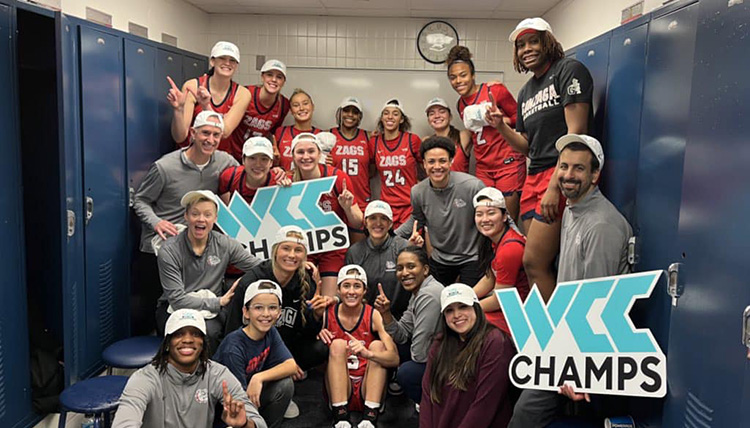 Gonzaga's Women's Basketball team and coaches celebrate being WCC champs in a locker room.