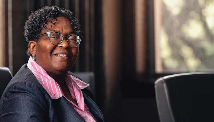 Charlita seated in an office