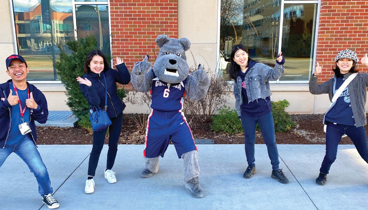 Spike the bulldog and students give thumbs up