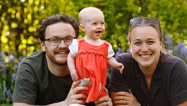 man and woman with baby