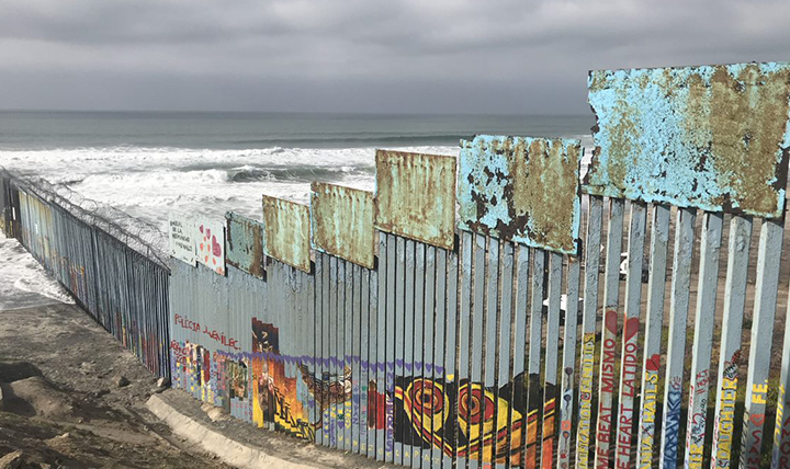 The Us-Mexico border wall extends into the Pacific Ocean.