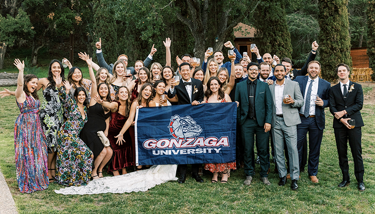 large wedding party outdoors with gonzaga flag