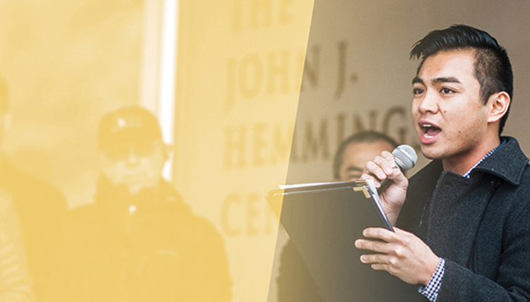 asian american male with microphone and yellow graphic treatment