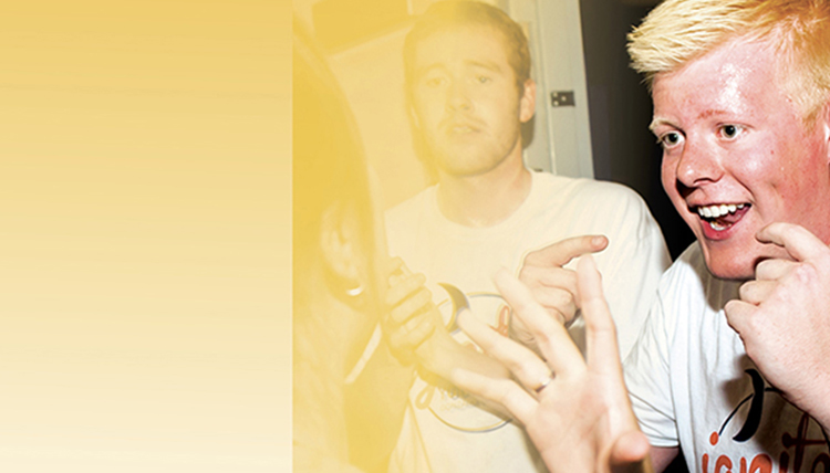 male student smiling with yellow treatment over image