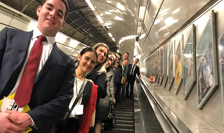 Students pose on the escalator in the London metro. 