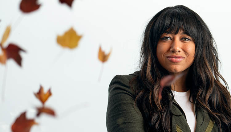 Mandi Price stands with leaves falling around her