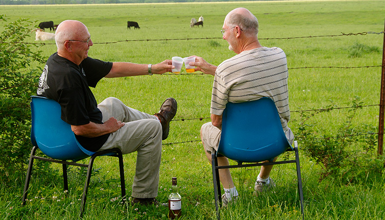 two elderly men having a drink in a rural area along route 66