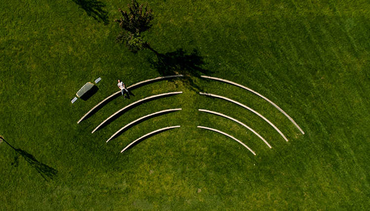 aerial shot of student lying in grass 
