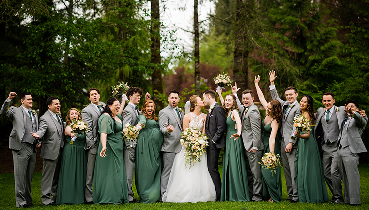 large wedding party outdoors in green and gray