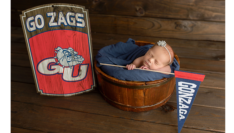 baby in a bucket with a gonzaga flag