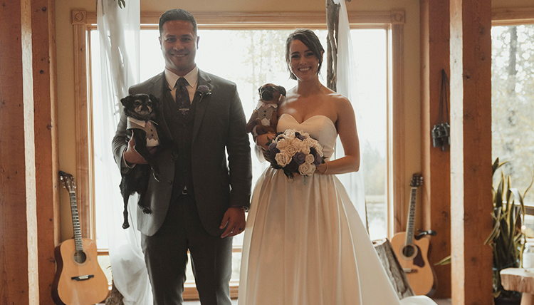 man and woman marry holding their dogs